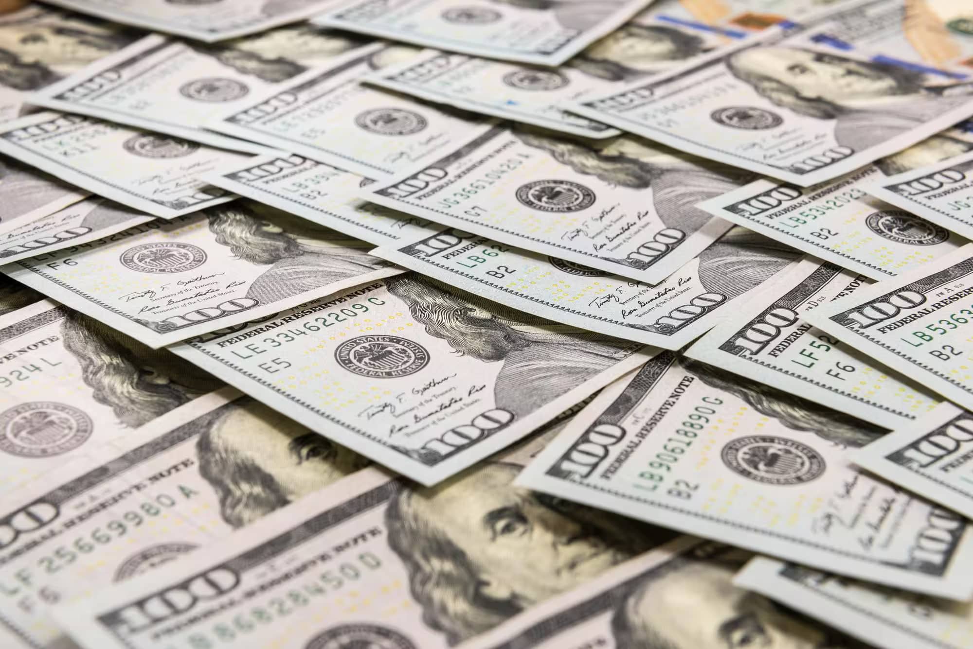 Piles of one hundred dollar bills