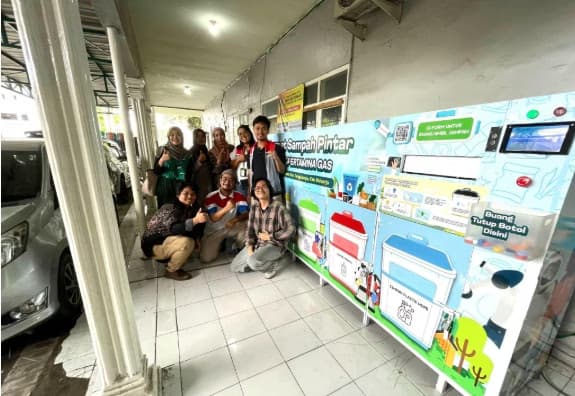 Pertamina Gas CSR team posing with smart trash bins installation