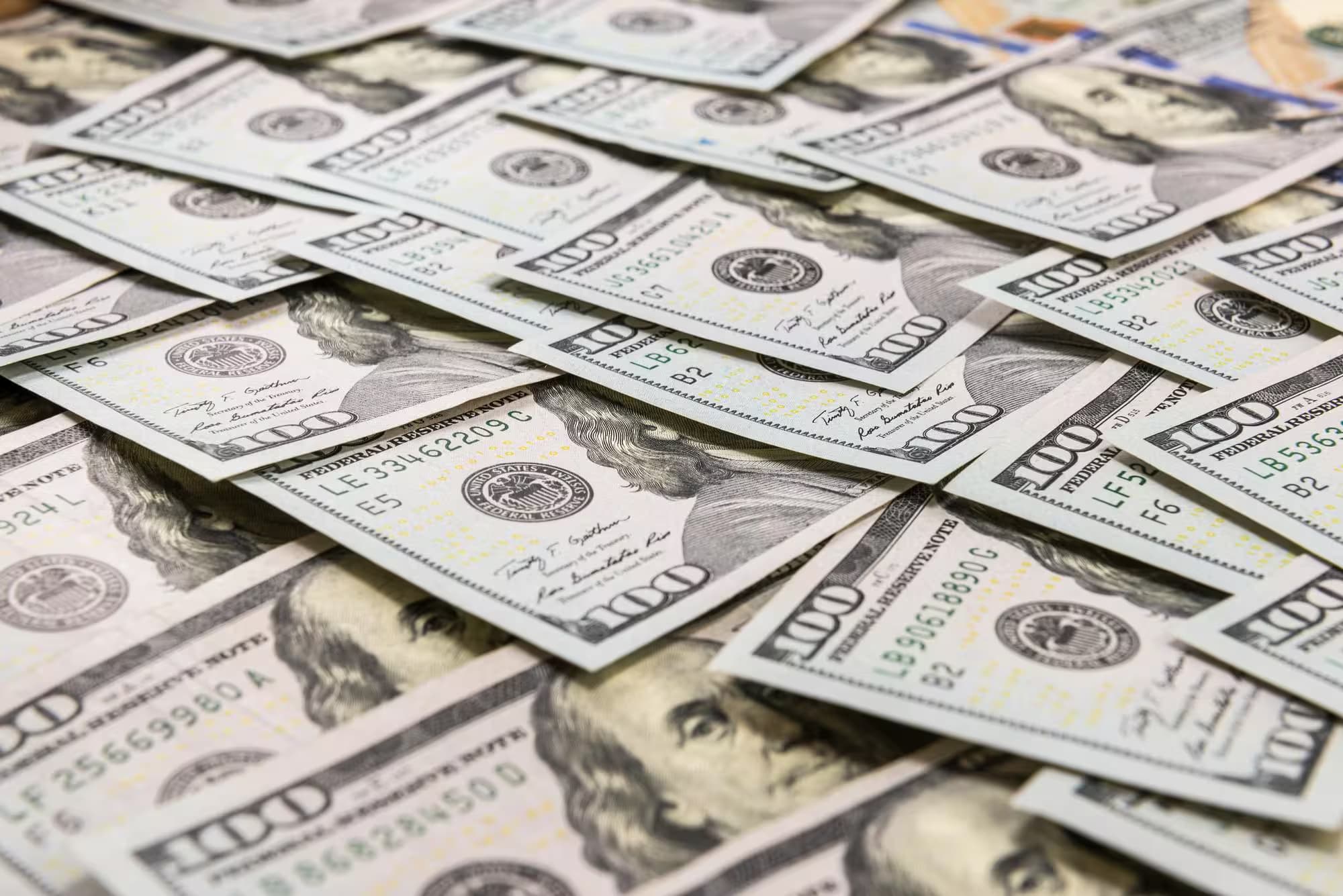 Piles of one hundred dollar bills